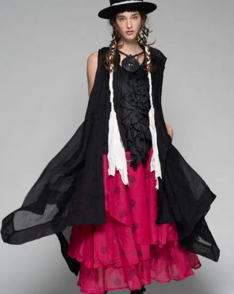 Model wearing Dogstar clothing a black and red dress with a long black shawl on a gray background
