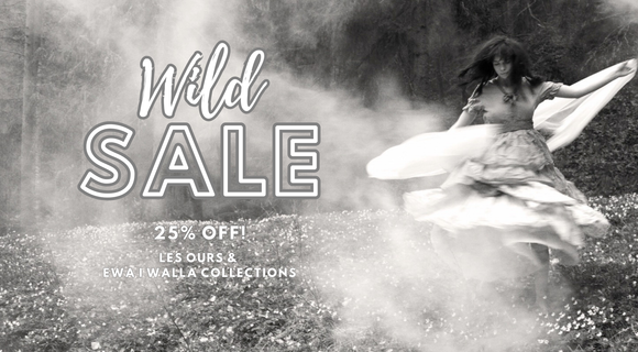 Black and white advertisement for a sale with a woman in a flowing dress.