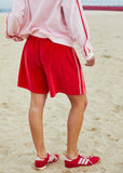 person wearing Hammil and co velour shorts red - Stay Wild Collective  