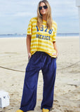 person wearing MEXICO 1976 STRIPE TEE - YELLOW STRIPE - Stay Wild Collective  
