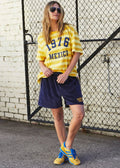 person wearing MEXICO 1976 STRIPE TEE - YELLOW STRIPE - Stay Wild Collective  