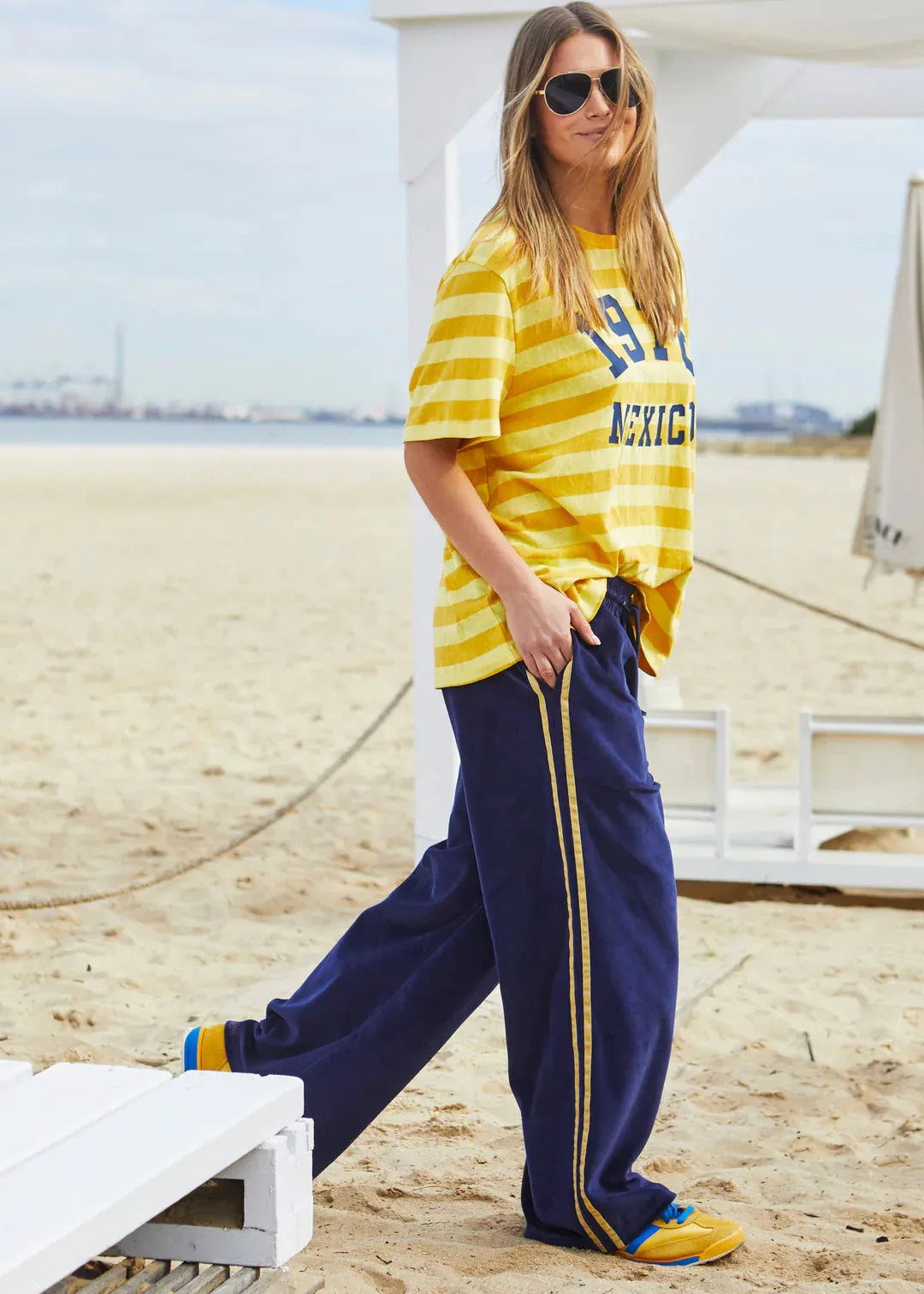 person wearing MEXICO 1976 STRIPE TEE - YELLOW STRIPE - Stay Wild Collective  