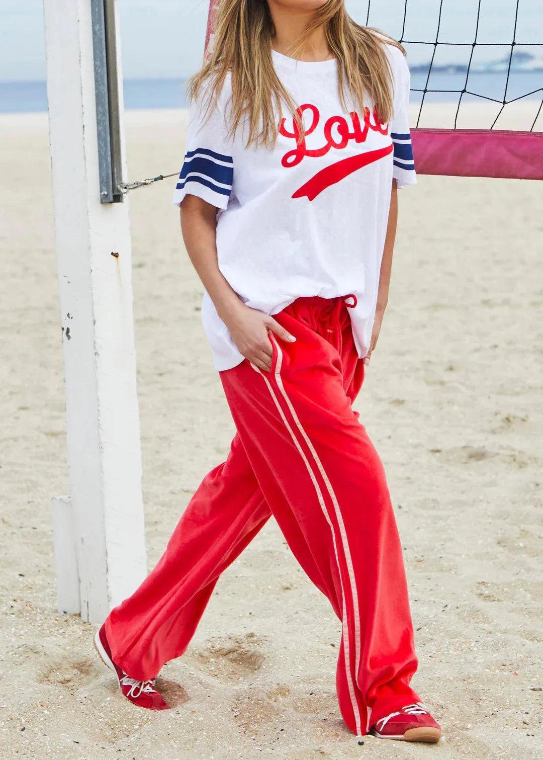 person wearing URBAN VELOUR PANT - RED/PINK - Stay Wild Collective  