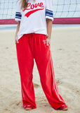person wearing URBAN VELOUR PANT - RED/PINK - Stay Wild Collective  