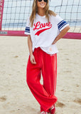person wearing URBAN VELOUR PANT - RED/PINK - Stay Wild Collective  