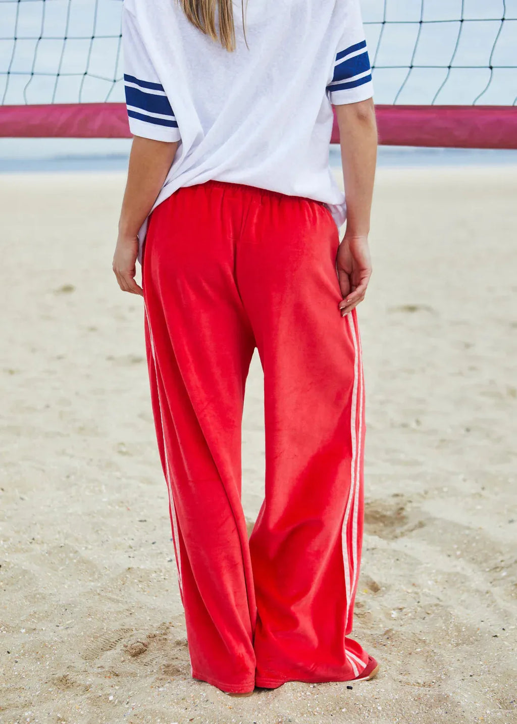 person wearing URBAN VELOUR PANT - RED/PINK - Stay Wild Collective  